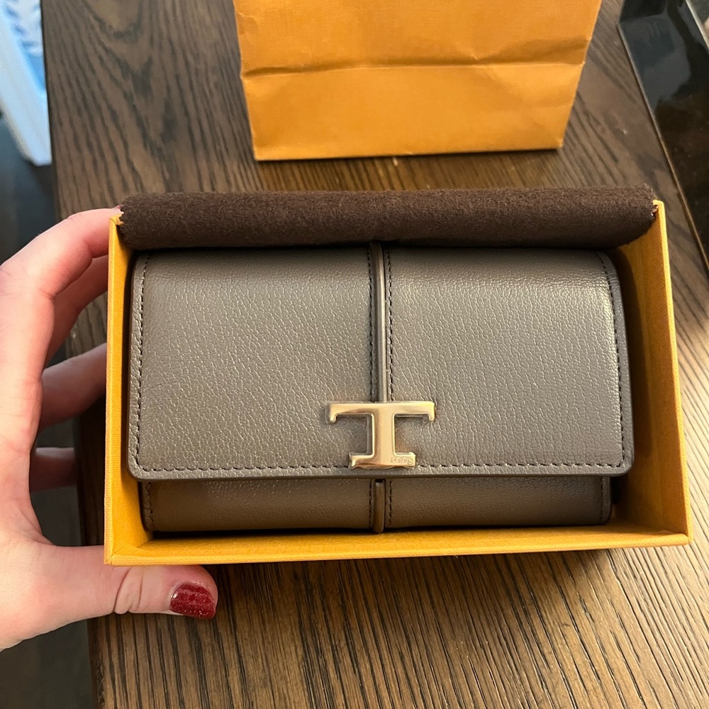 Tan long wallet with textured leather and gold-toned closure